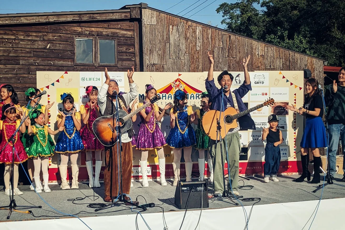 出演者と子どもたちがステージでパフォーマンスする様子